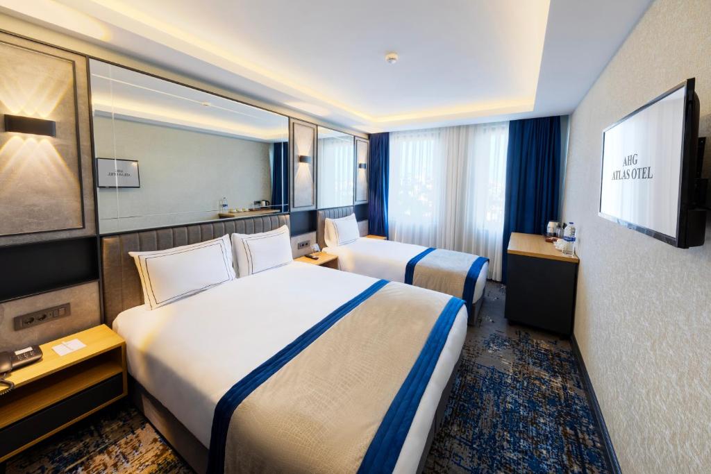 Säng eller sängar i ett rum på AHG Atlas Hotel Taksim