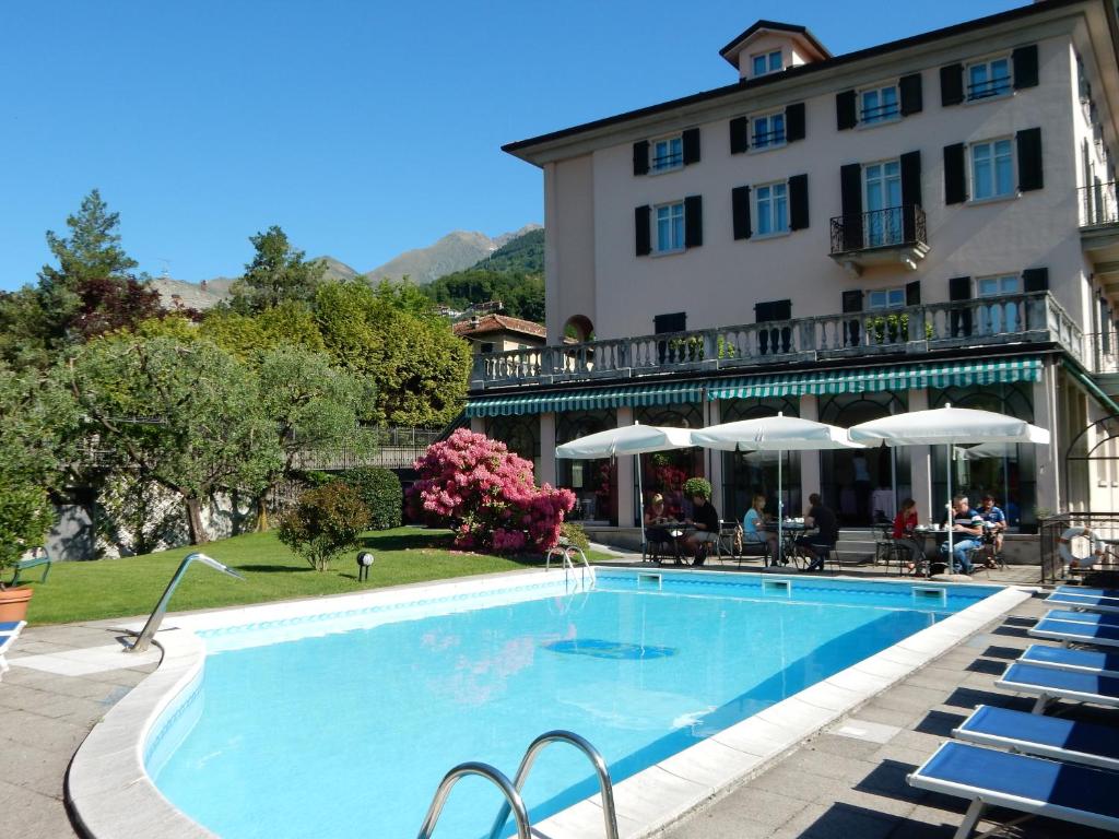 a large swimming pool in front of a building at Hotel La Villa in Gravedona