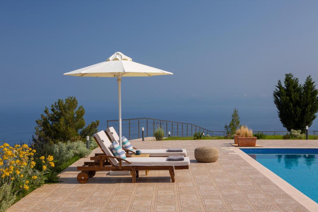 a chair and an umbrella next to a swimming pool at Avraam Sunset Villas with Private Heated Pools by Imagine Lefkada in Kalamitsi