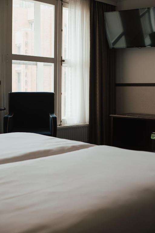 Postel nebo postele na pokoji v ubytování Boutique Hotel De Doelen