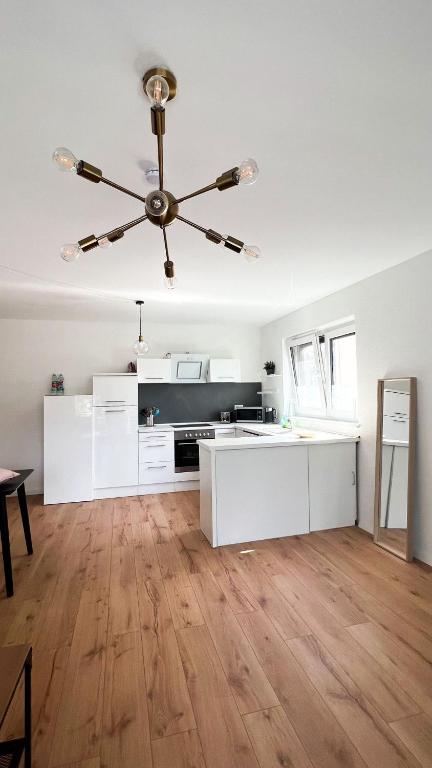 a kitchen with white cabinets and a ceiling fan at 2 ZKB Apartment in Mannheim in Mannheim