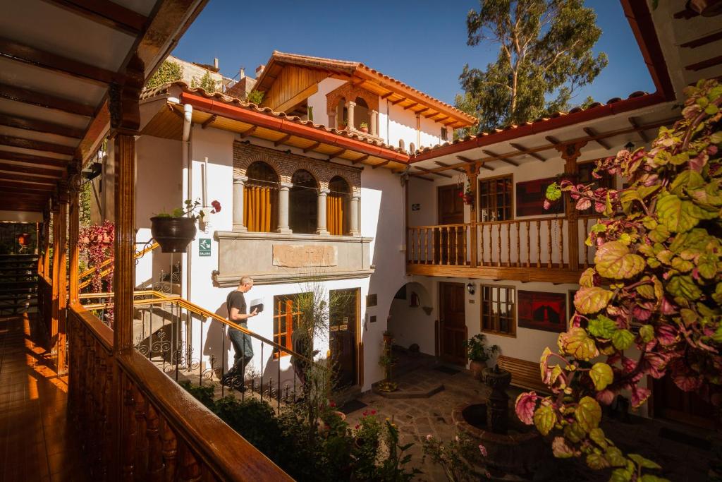 a man standing in the doorway of a building at Hotel Rumi Punku in Cusco