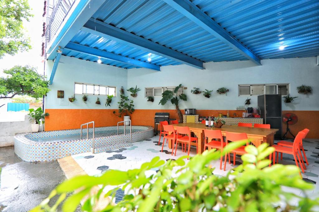 a restaurant with blue ceilings and tables and chairs at Fumigate Hotel in Hengchun South Gate