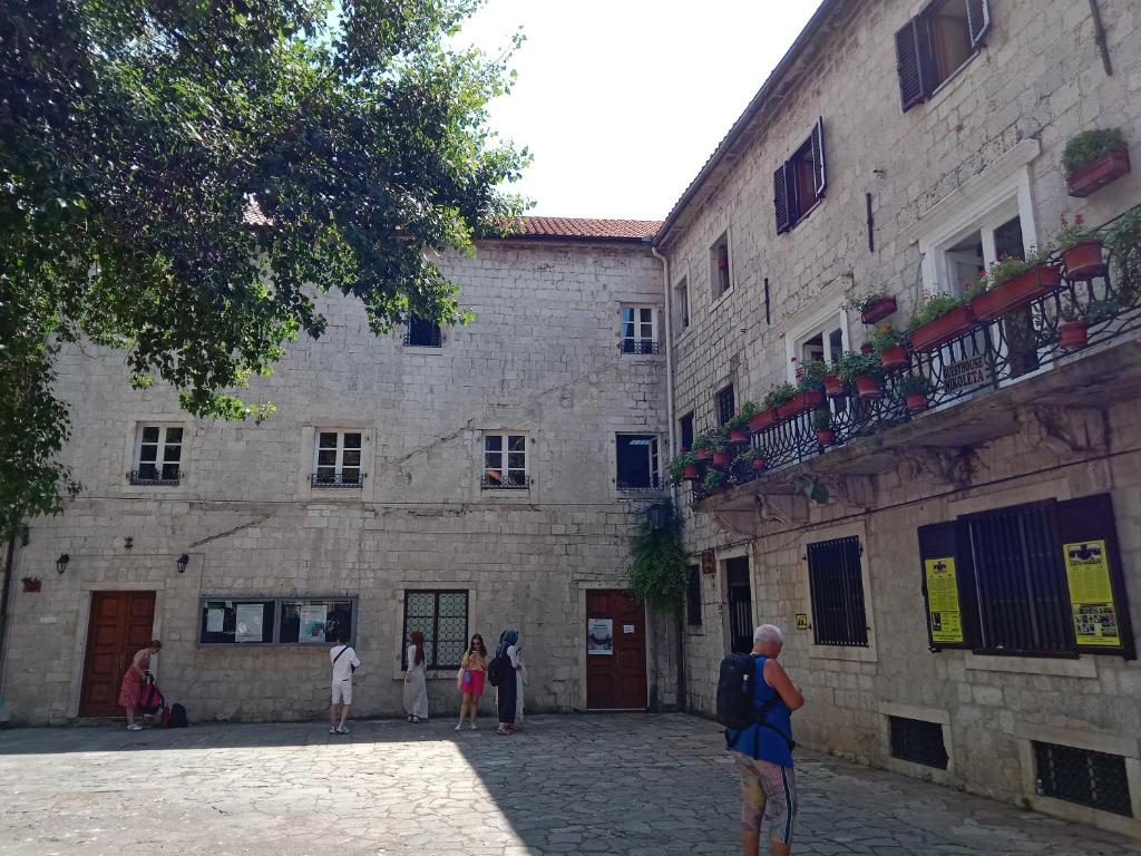 a group of people standing outside of a building at Centar Starog Grada in Kotor