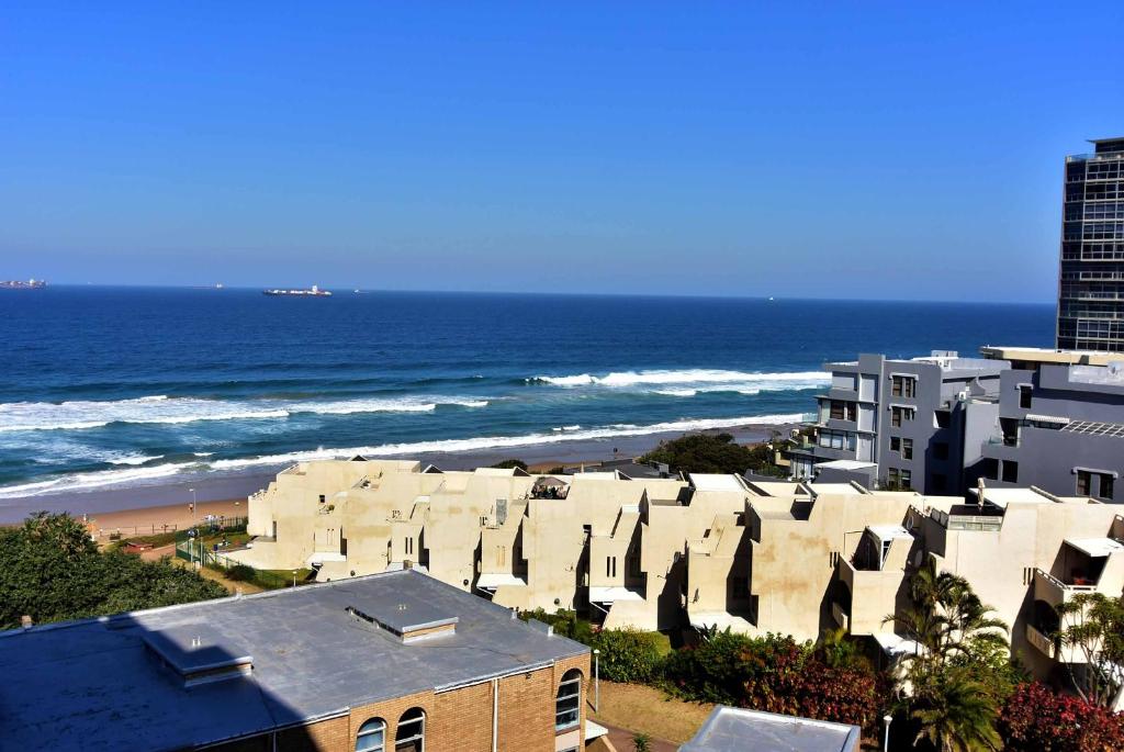 a view of a beach with buildings and the ocean at 503 Hawaan View in Durban