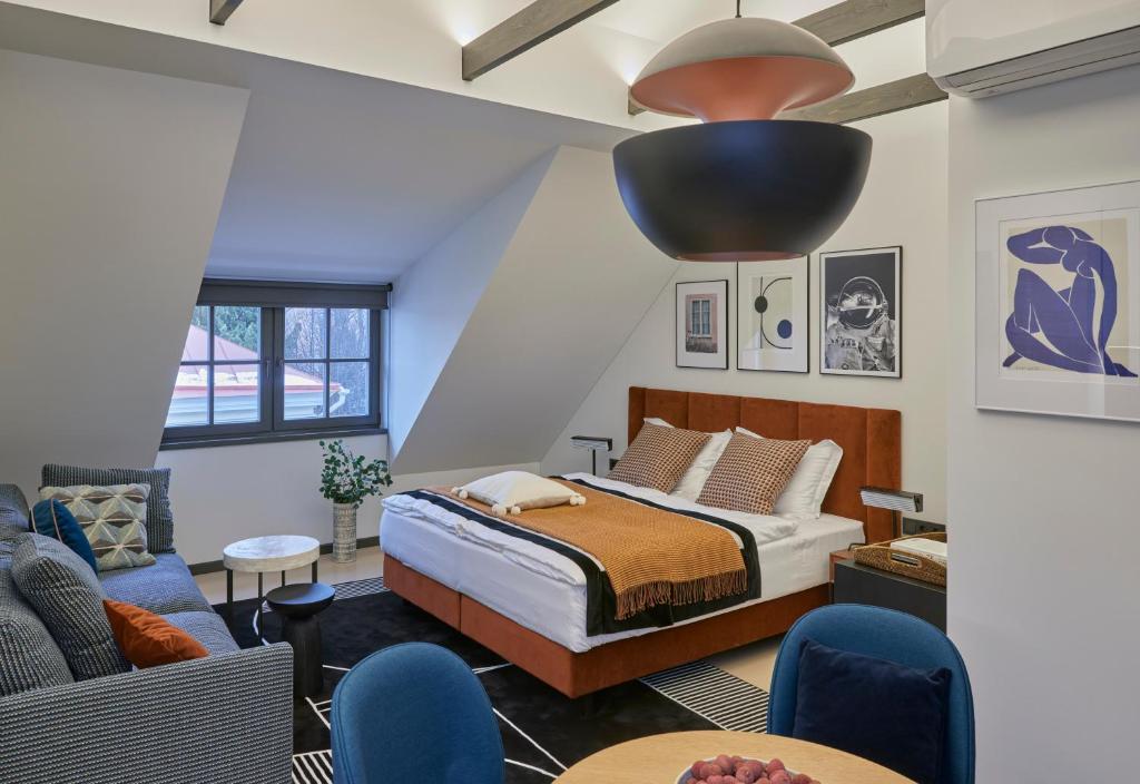 ROOMA Apartments — A bedroom with a bed and a living room