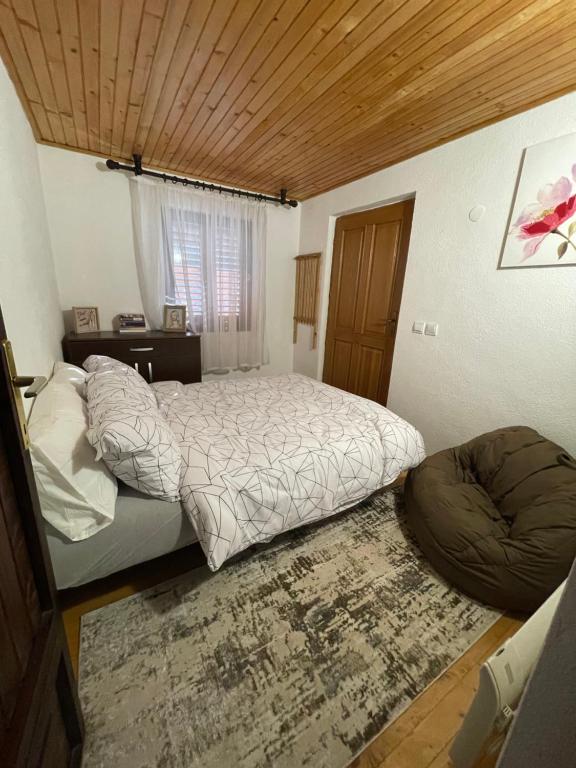 a bedroom with a large bed and a wooden ceiling at Krupa na Vrbasu - Krupski raj in Banja Luka