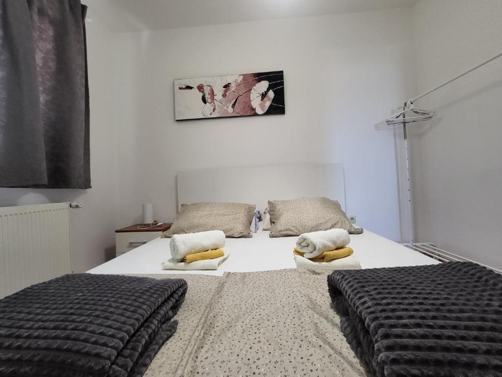 a bedroom with two beds with pillows on them at Apartment Magdalena in Sveti Filip i Jakov