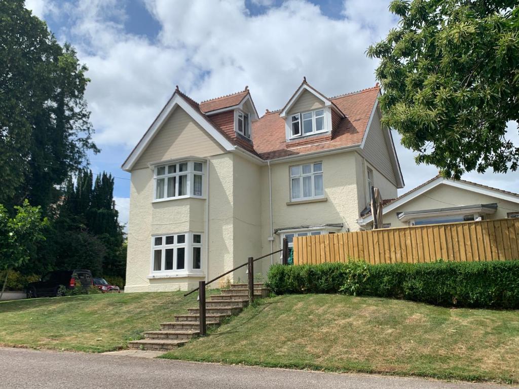 a house with a fence in front of it at En-Suite rooms, Colyford in Colyford