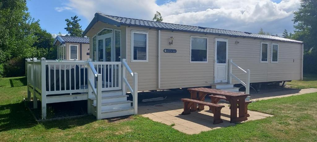 a tiny house with a bench and a table at The Chill Out at Seton Sands in Port Seton