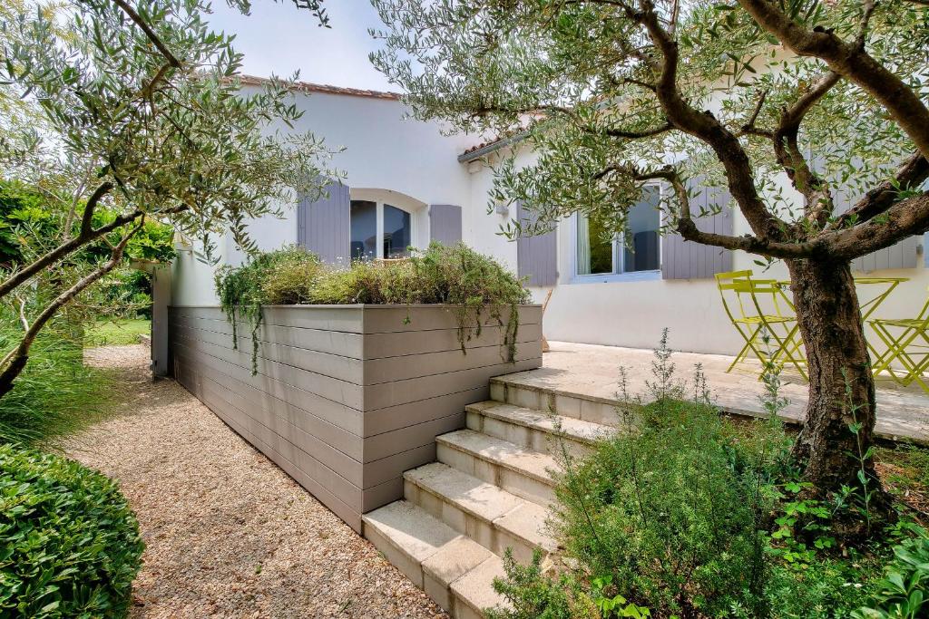 a house with a retaining wall and stairs at Havre de paix pour 10 a l Ile de Re in La Flotte