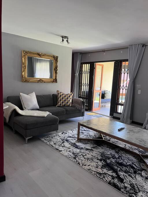a living room with a couch and a coffee table at Iyana Place in Midrand
