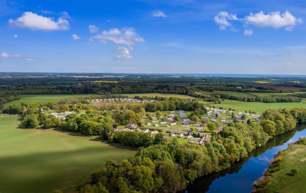 an aerial view of a large estate next to a river at Springwood Holiday Park in Kelso