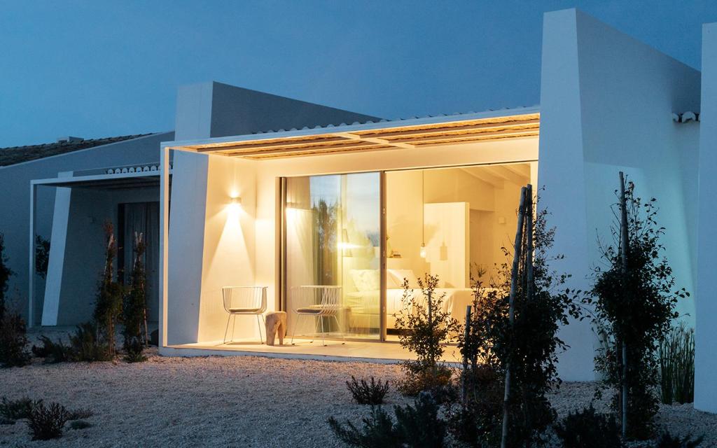 a white house with a large glass door at Amaria in Aljezur