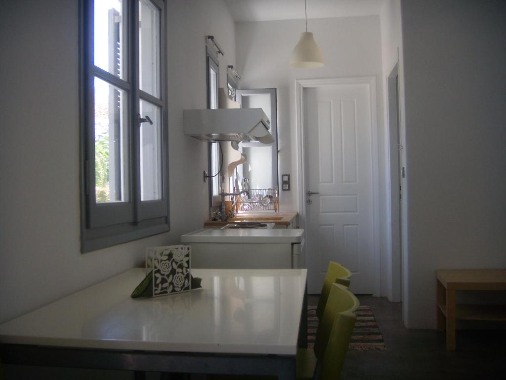 a white room with a table and a mirror at Cristi Rooms in Livadi
