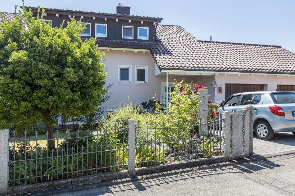 a house with a car parked in front of it at Haus Unterseeblick - Sonnenaufgang in Gaienhofen