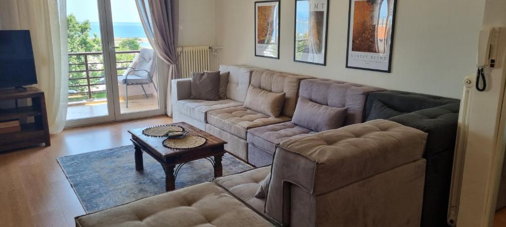 a living room with a couch and a table at Amazing sea view apartment in the city center! in Alexandroupoli