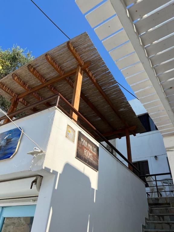 a sign on the side of a house with a roof at Maya Mallis in Adamas