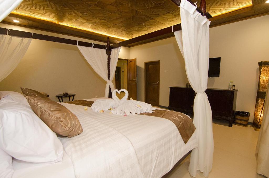 Letto o letti in una camera di Syailendra Hotel Syariah