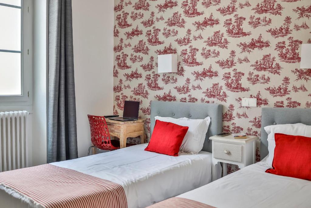 Postel nebo postele na pokoji v ubytování Hôtel Parc Mazon-Biarritz