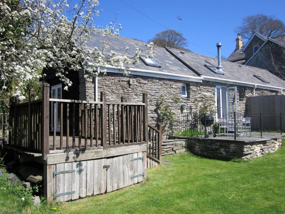 a stone house with a wooden gate in the yard at Mount Barn in Newcastle Emlyn