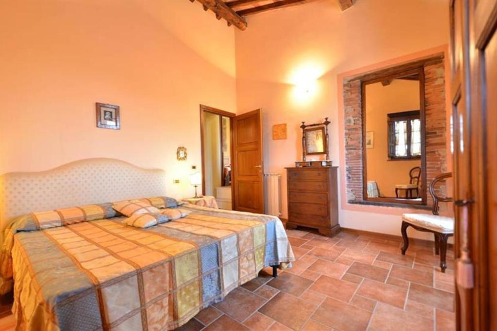 Schlafzimmer mit einem Bett und einem Spiegel in der Unterkunft Francesca 2 Senior suite Villa Ricetro in Luciano