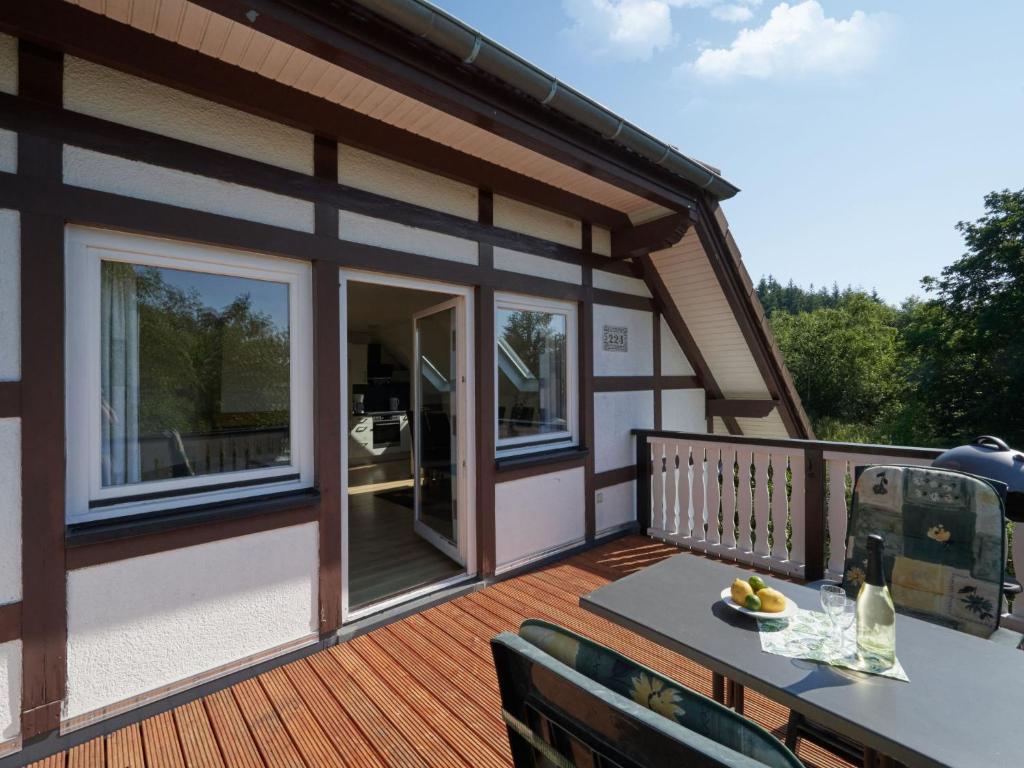 a large deck with a table and chairs on it at Apartment Am Sternberg 224 by Interhome in Frankenau