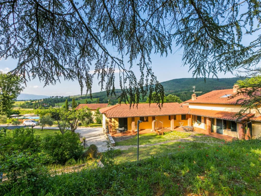 a house with a mountain in the background at Holiday Home Ginestra by Interhome in Badia Agnano