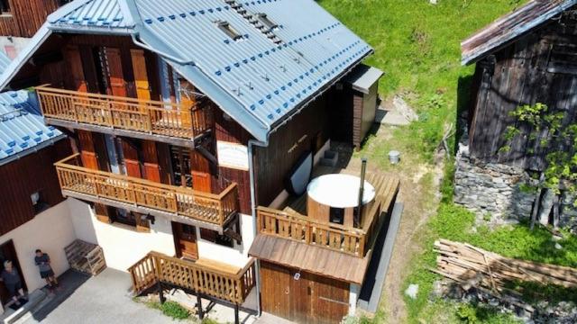 an overhead view of a building with a blue roof at CHALET LA RIOULE 16 pers in Doucy
