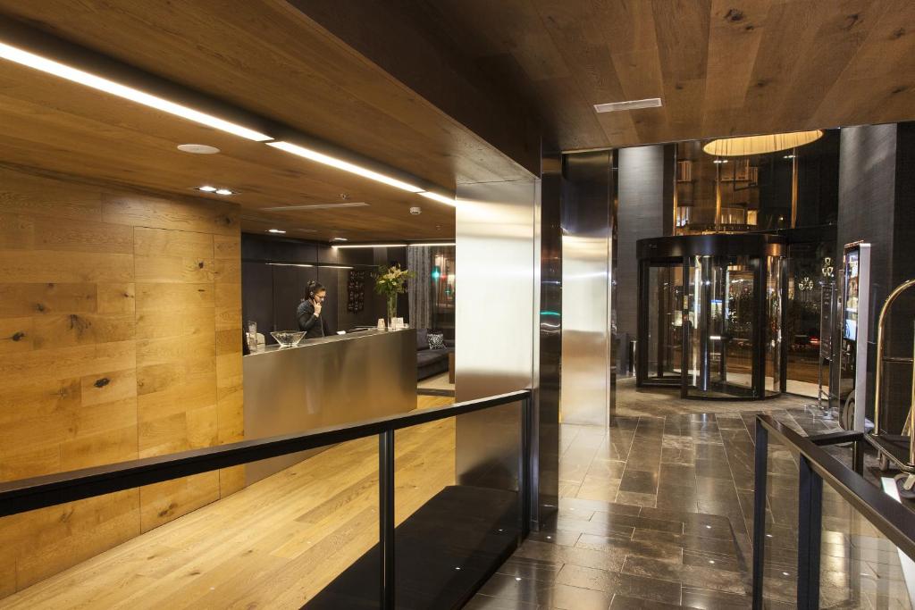 a lobby of a building with a person in the mirror at Zenit Vigo in Vigo