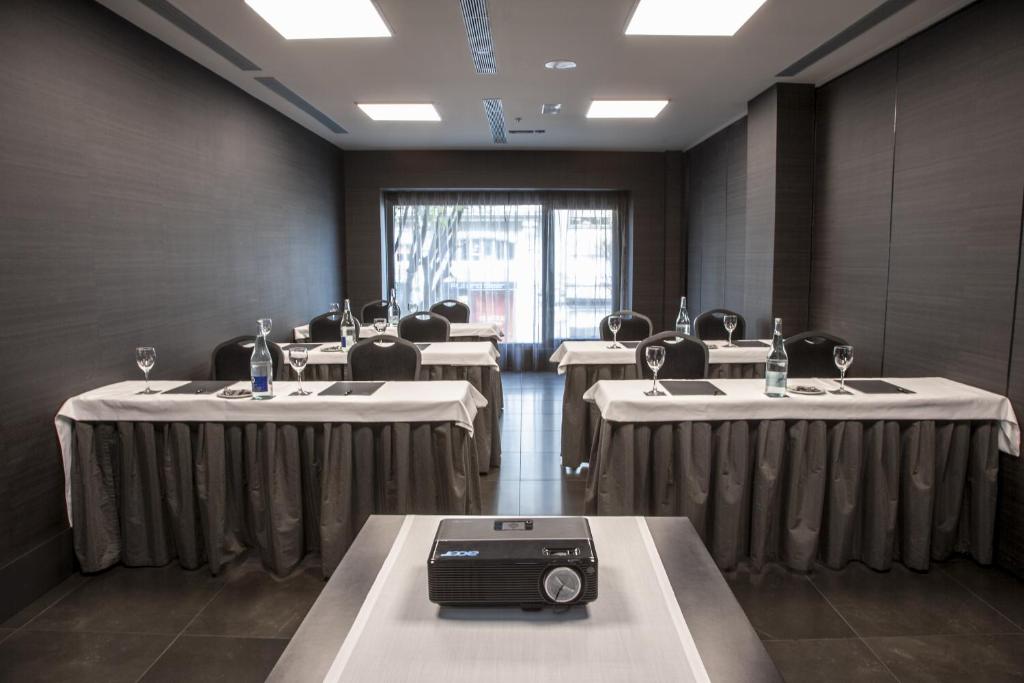 a dining room with tables and chairs and a room with tables at Zenit Vigo in Vigo