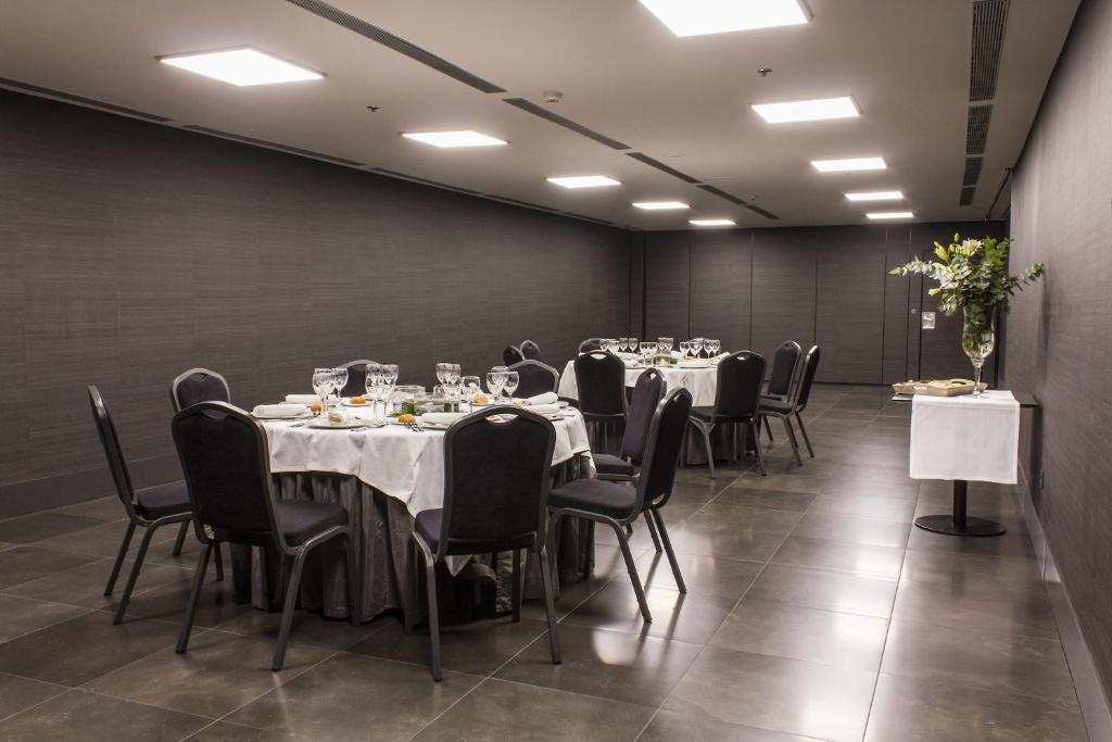 a conference room with tables and chairs in it at Zenit Vigo in Vigo