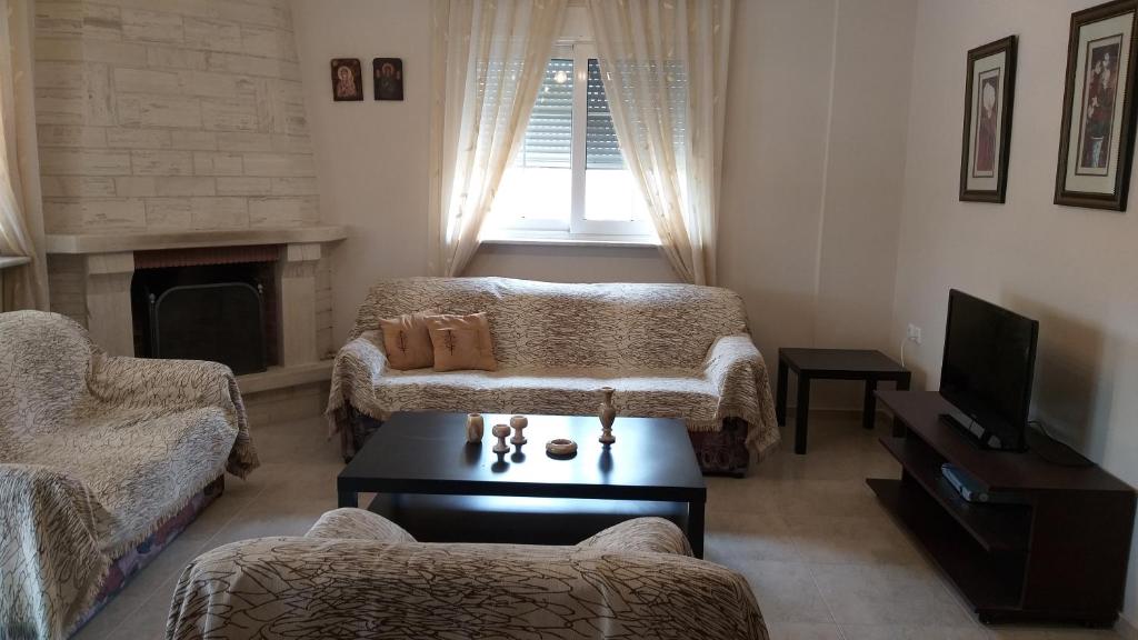 a living room with a couch and a coffee table at Evelins house Alexandroupoli in Alexandroupoli