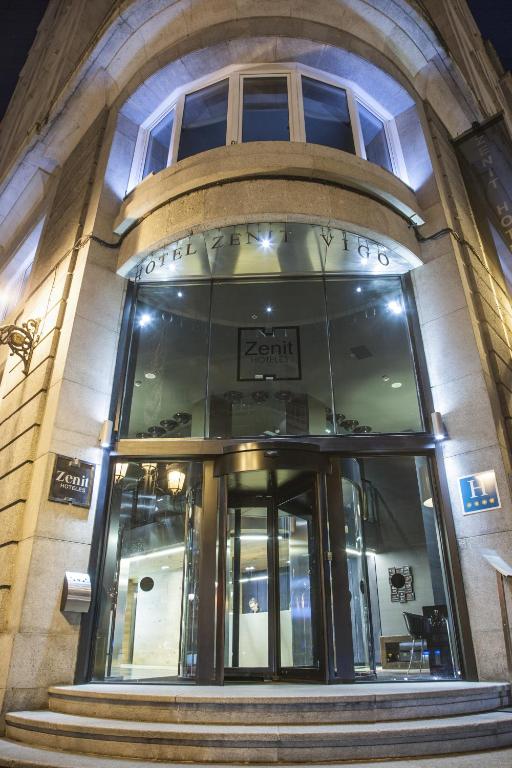 a building with a revolving door in front of it at Zenit Vigo in Vigo