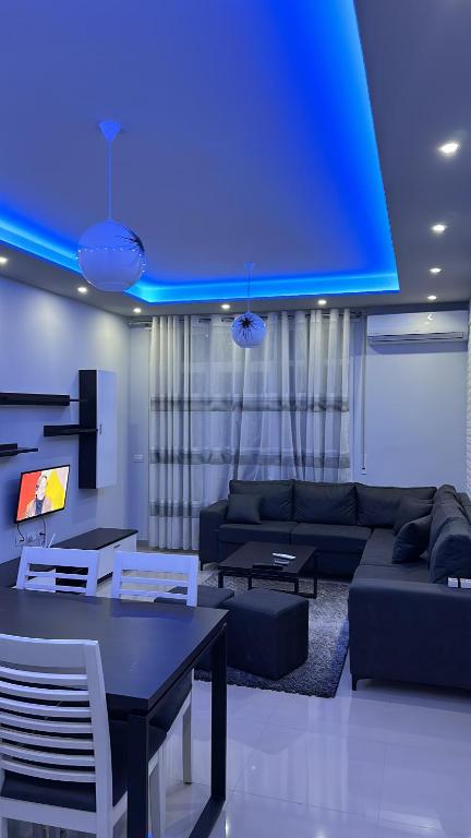 a living room with a couch and a blue ceiling at Tirana Rent Apartment in Tirana