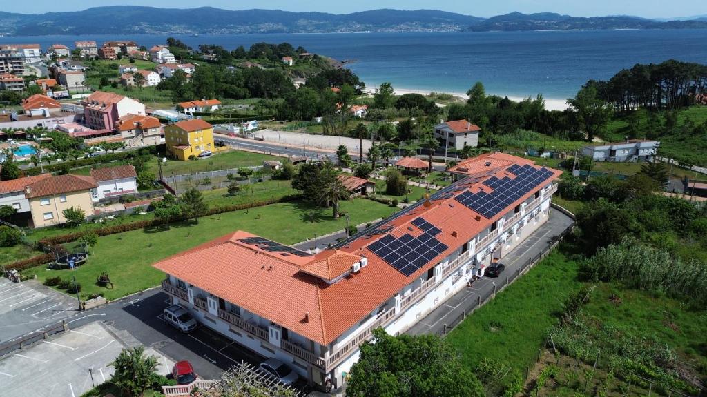 an aerial view of a building with solar panels on its roof at Aparthotel Cabicastro in Portonovo