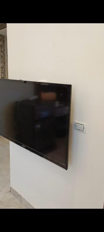 a flat screen tv sitting on a white wall at ميراج باى in Safaga