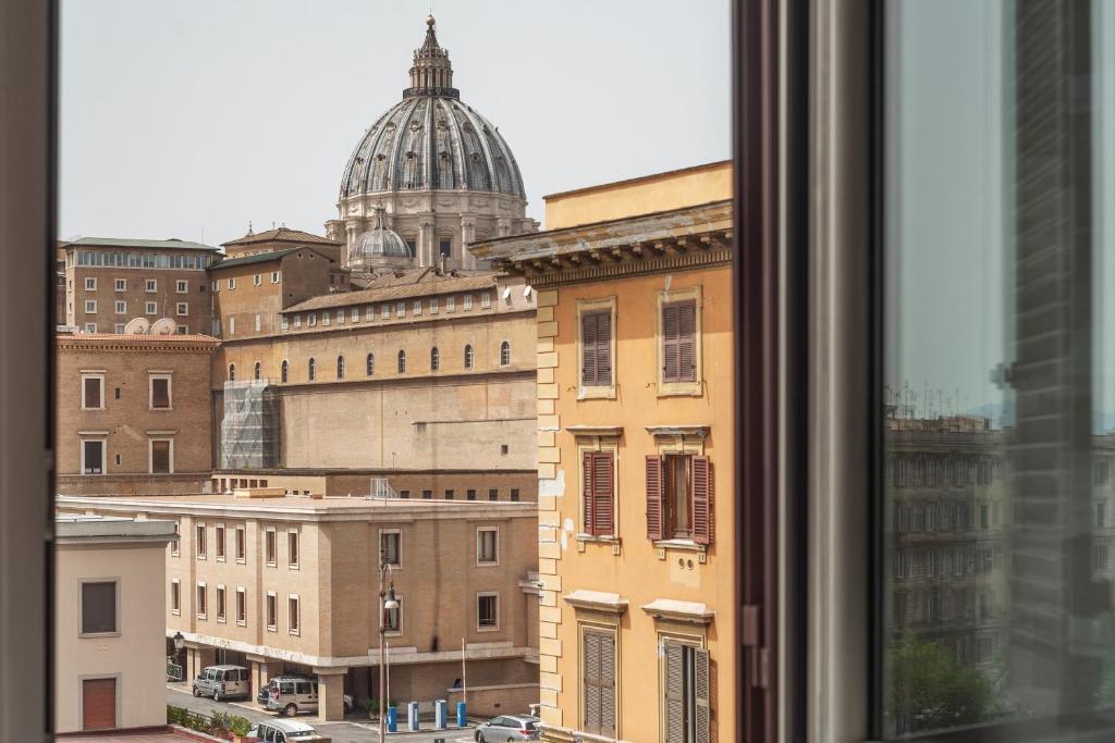 a view of a city from a window at Vista su San Pietro - la Venere su Roma Apartment in Rome