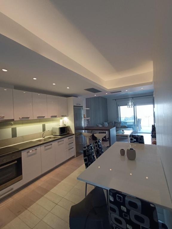 a large kitchen with a table and chairs at Peramos View Luxury Maisonette in Nea Peramos