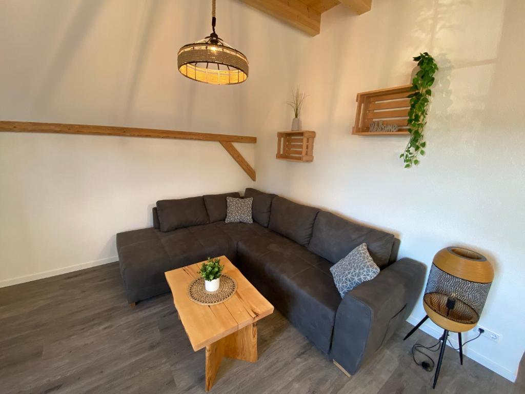 a living room with a couch and a table at Ferienwohnungen Etzl in Bad Mergentheim