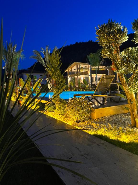 a villa with a swimming pool at night at Cirali Hestia Lodge in Kemer