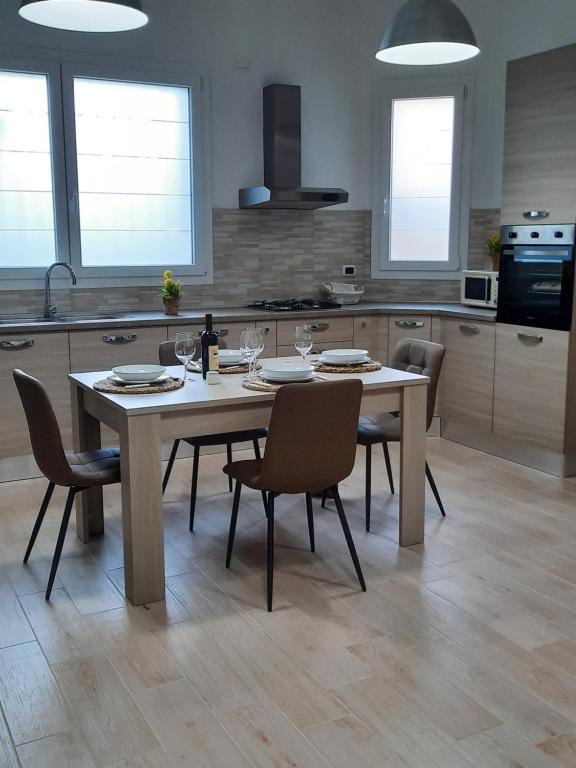 a kitchen with a table and chairs in a kitchen at Holiday Home Dolia Center in Dolianova