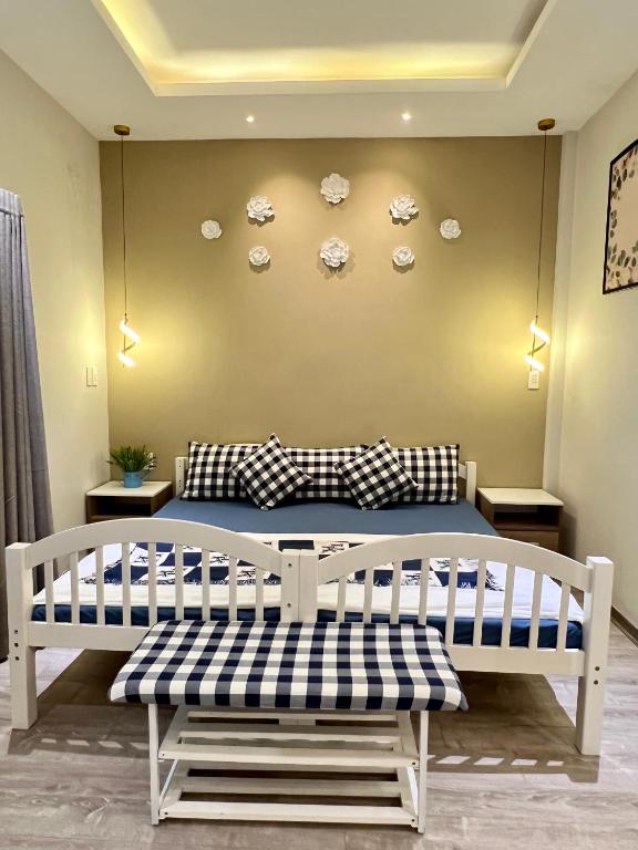 a bedroom with a bed with plates on the wall at Kata Home in Danang