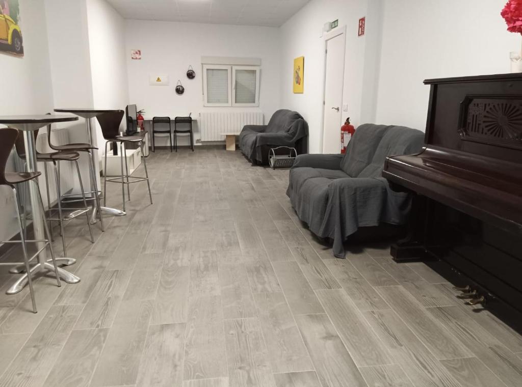 sala de estar con piano y sillas en PENSION IRATI en Rincón de Soto