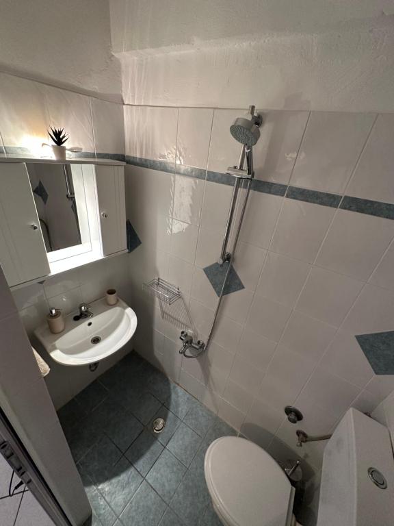 a bathroom with a toilet and a sink at Valente Rooms Kythira in Kythira