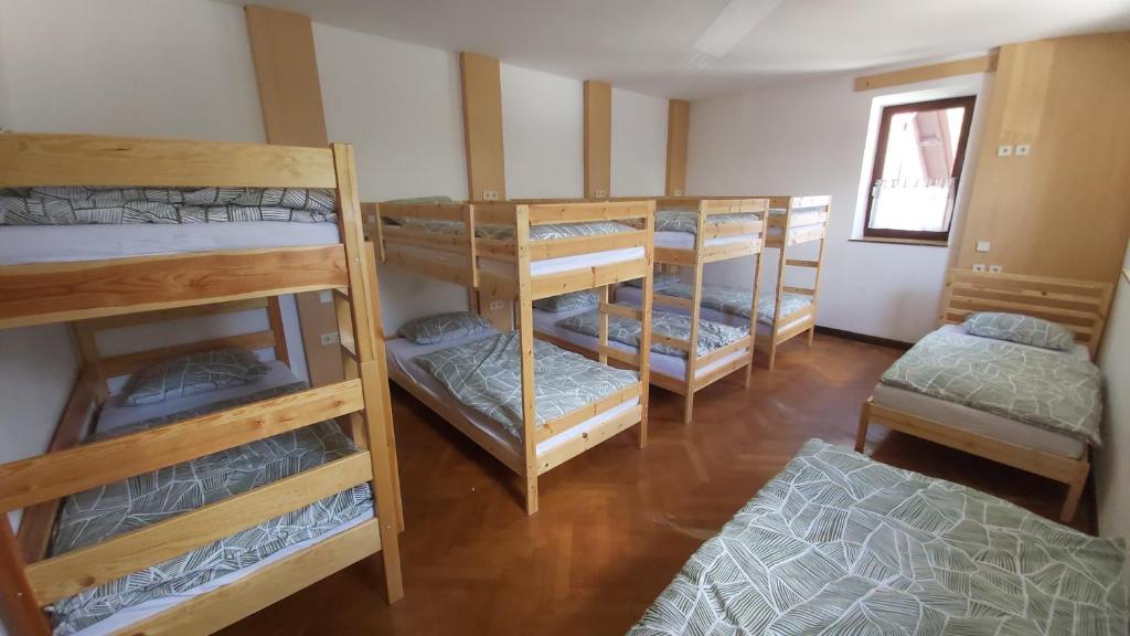 a group of bunk beds in a room at Hostel in picerija Špajza in Mojstrana