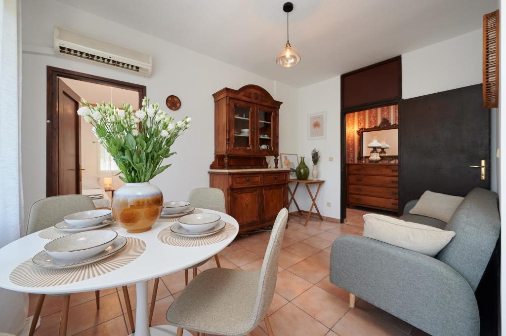 a dining room with a white table and chairs at Zen Garden Sew View Apartment in Trogir