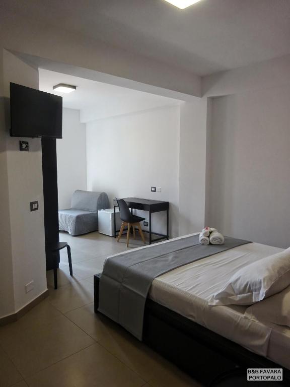 Postel nebo postele na pokoji v ubytování FAVARA Rooms