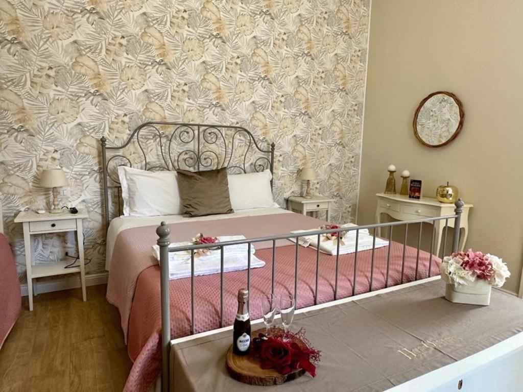 a bedroom with a bed and a flowery wall at Home Pompei Olympus in Pompei