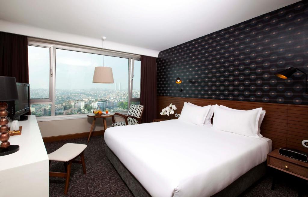 a hotel room with a large bed and a window at The Marmara Pera in Istanbul